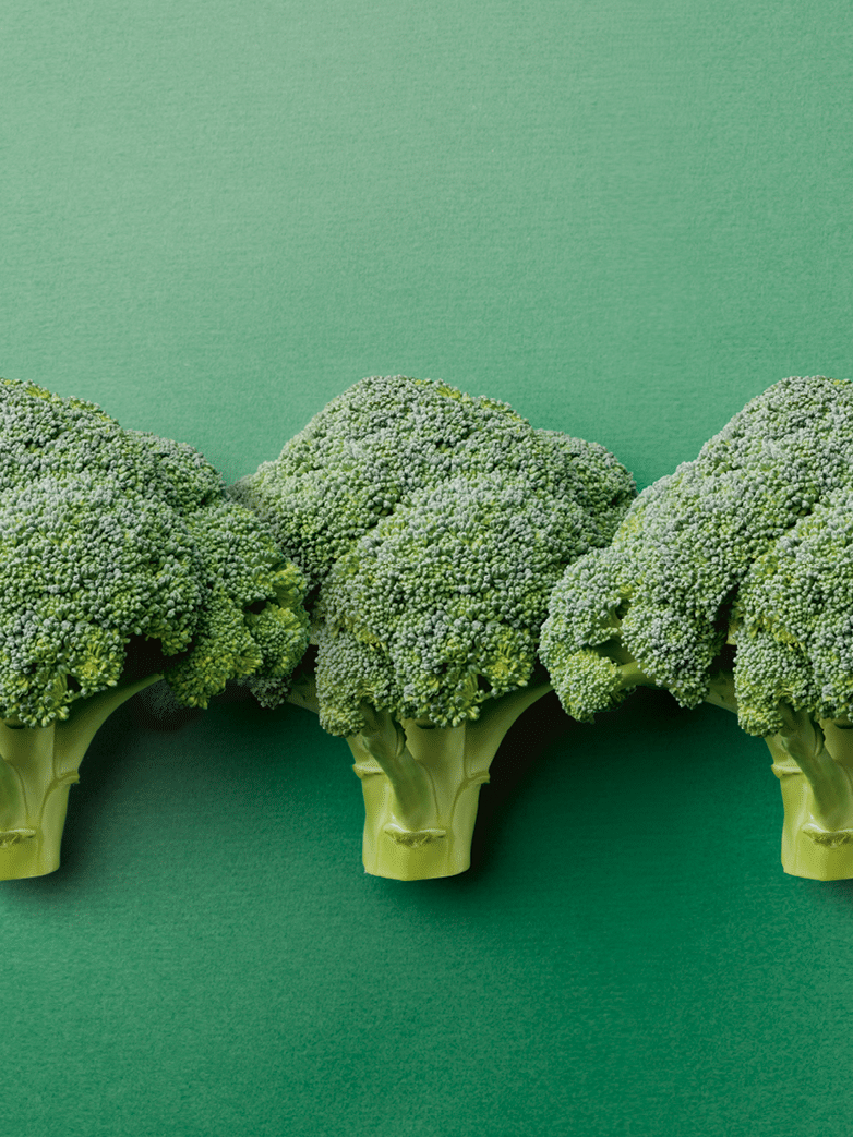 Broccoli on a green background with copy space.